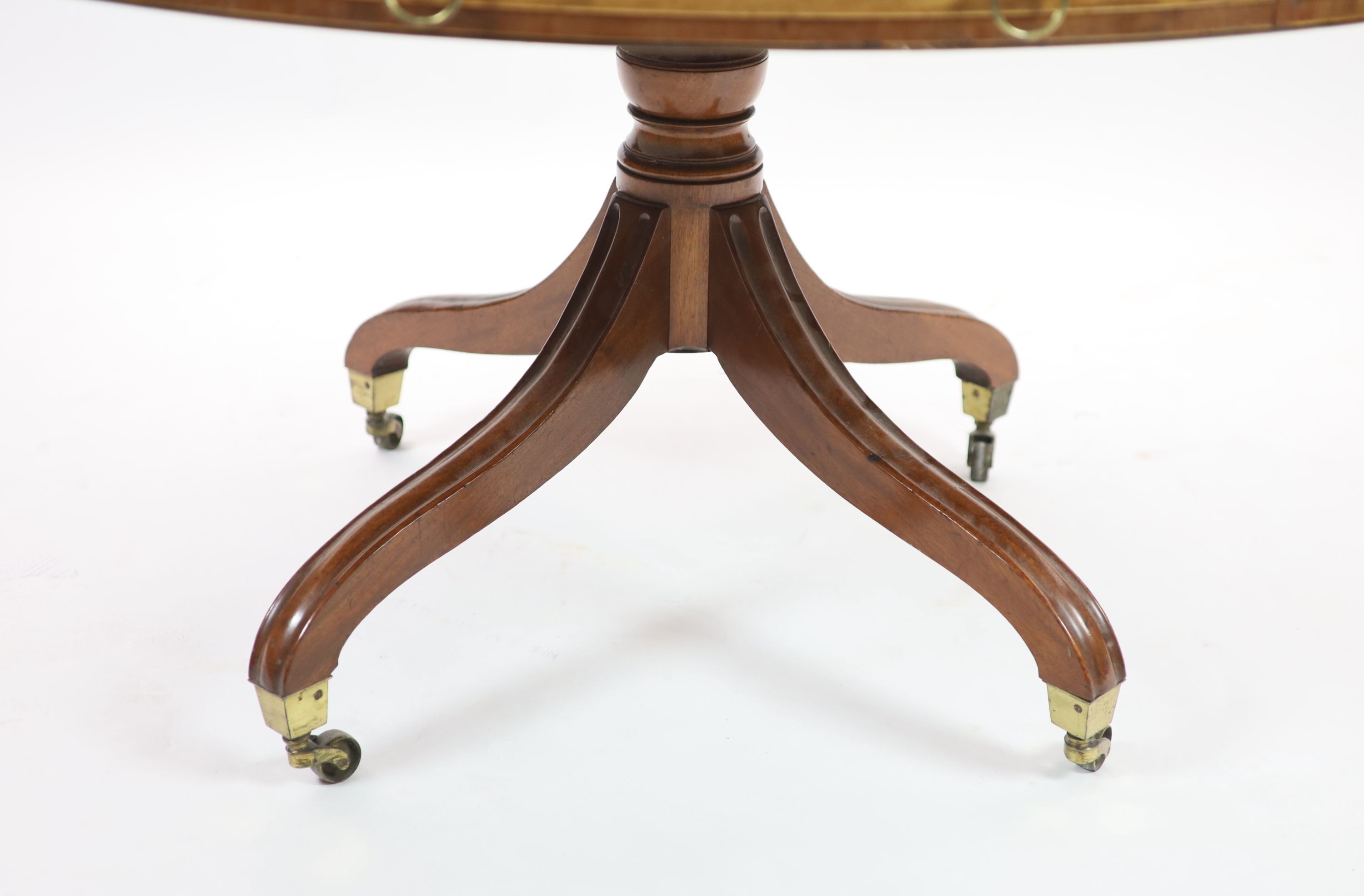 A Regency mahogany oval topped library table, H 78cm. Top 138 x 122cm.